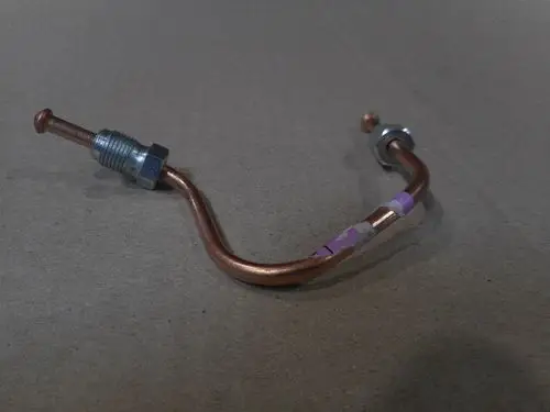Remeha Druckleitung mit gewundenem Kupferrohr und Anschlussstücken, geeignet für Pumpeninstallationen.